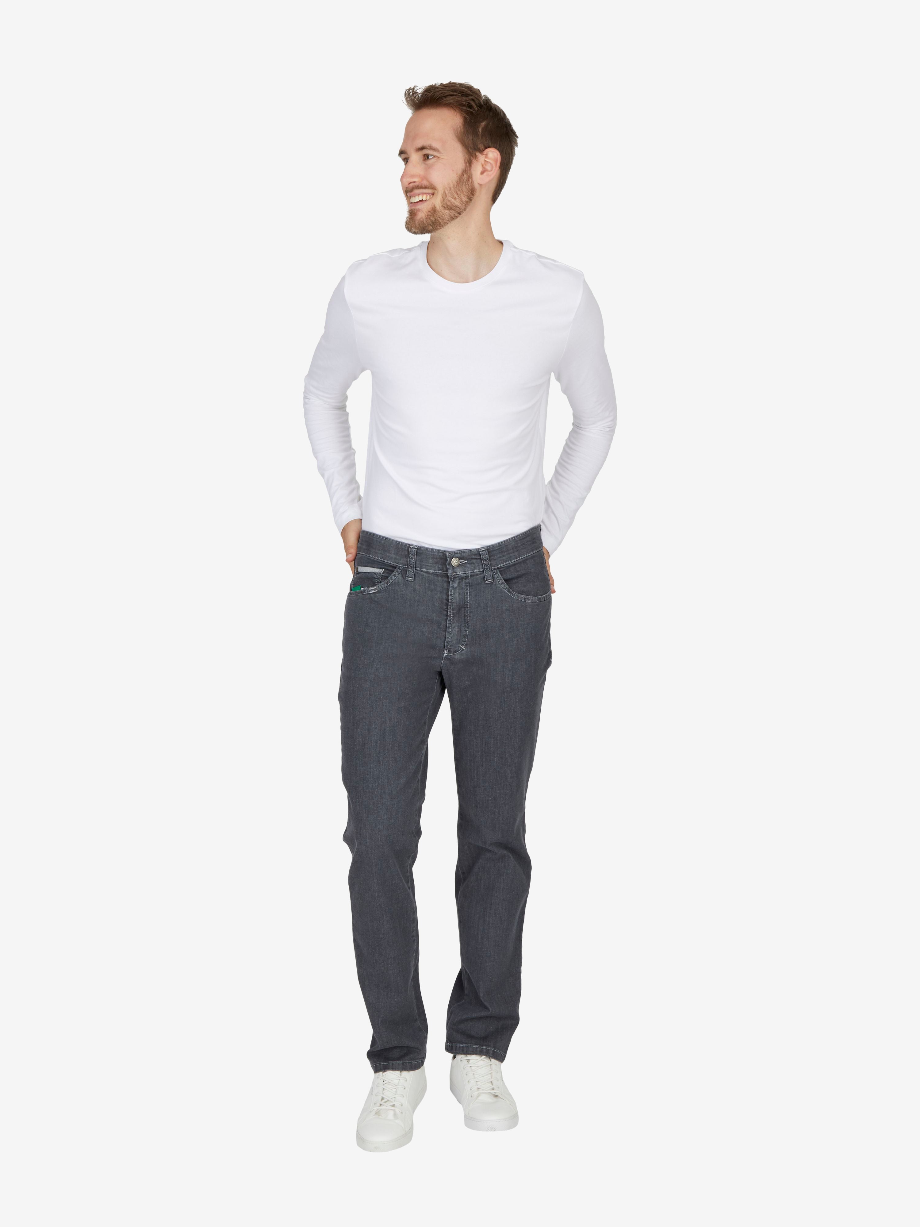 Mann trägt graue HENRY-X6516 7-Pocket Jeanshose in Regular Fit mit elastischem Doppelstoffbund, Mobile Pocket, Leistentasche mit Reißverschluss, hergestellt aus hoch elastischem, strapazierfähigem Super High Stretch-Denim, kombiniert mit weißem Langarm-Shirt.